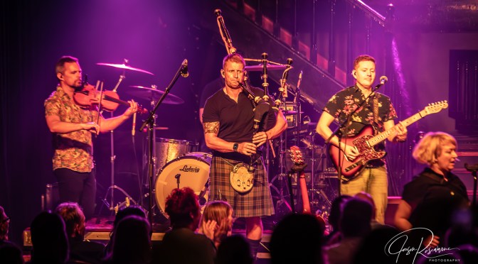 Skerryvore on stage with fiddle, bagpipes and electric guitar